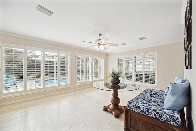 sitting room with ornamental molding, a wealth of natural light, ceiling fan, and light tile patterned floors