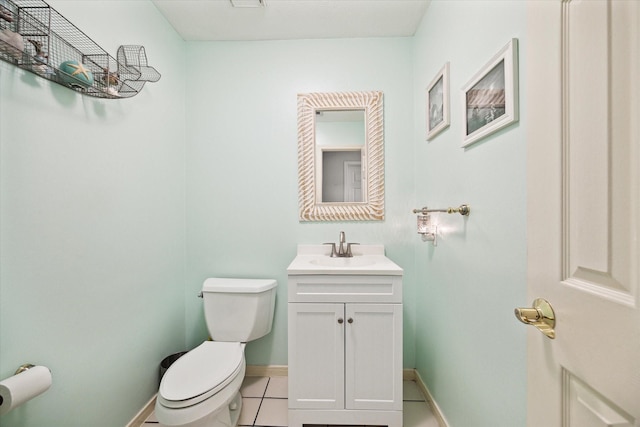 bathroom featuring vanity, tile patterned flooring, and toilet