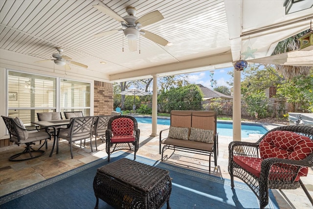 view of patio with ceiling fan and a fenced in pool