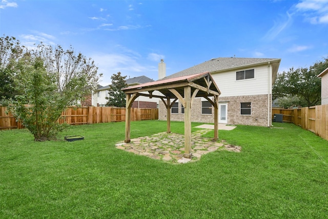 rear view of house featuring a fenced backyard, central AC unit, and a yard