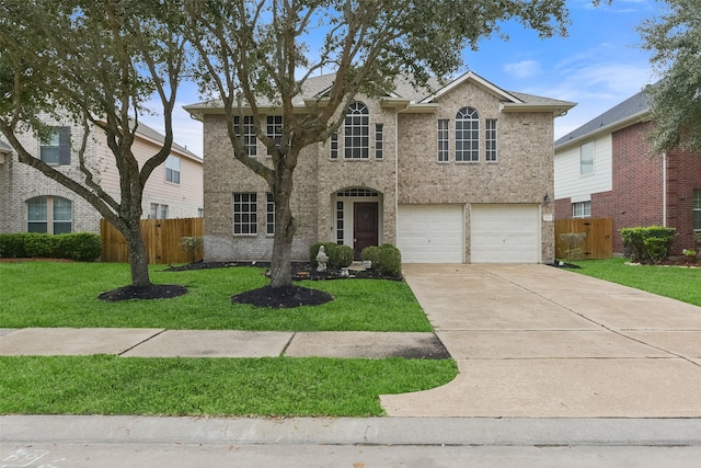 traditional home with brick siding, concrete driveway, fence, a garage, and a front lawn