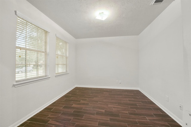 spare room featuring a textured ceiling