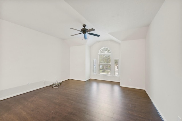 spare room featuring lofted ceiling, dark hardwood / wood-style floors, and ceiling fan