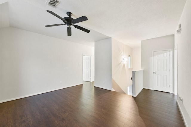 empty room with dark wood-style floors, baseboards, visible vents, and ceiling fan