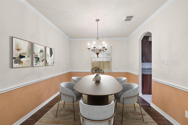 dining room featuring arched walkways, wood finish floors, visible vents, and crown molding