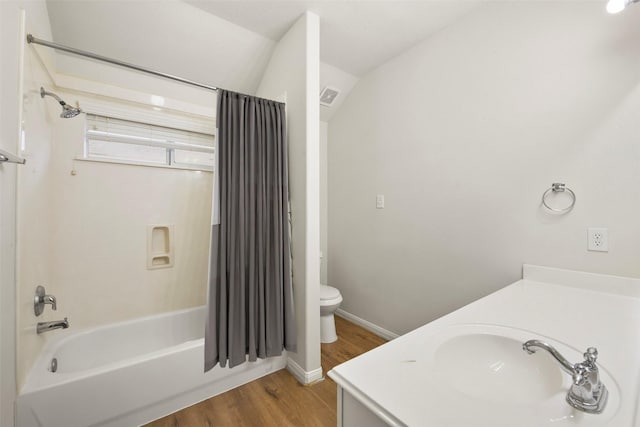 bathroom with visible vents, toilet, shower / bath combo, vanity, and wood finished floors