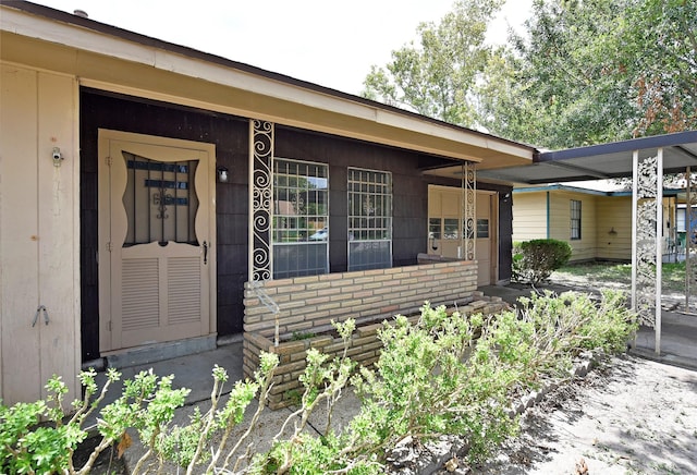 property entrance with a carport