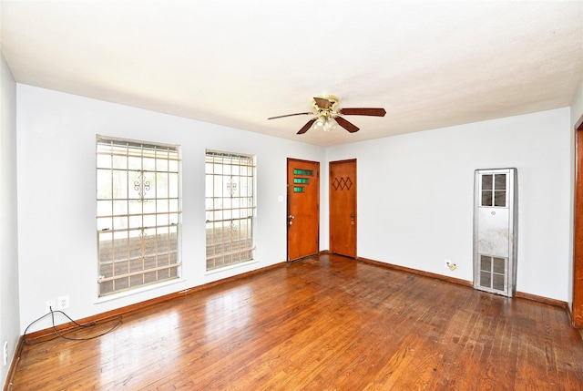 unfurnished room featuring hardwood / wood-style floors and ceiling fan