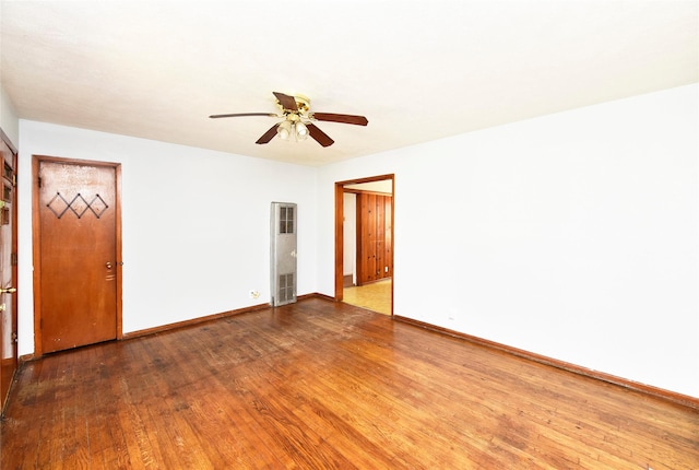 spare room with hardwood / wood-style floors and ceiling fan