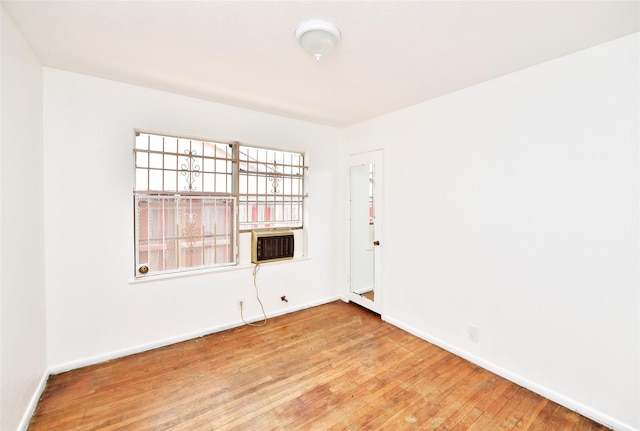 empty room with cooling unit and hardwood / wood-style floors