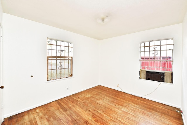 unfurnished room with hardwood / wood-style flooring and cooling unit