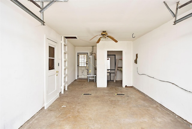 interior space featuring water heater, concrete floors, and ceiling fan