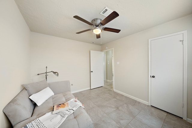 unfurnished room featuring a textured ceiling and ceiling fan