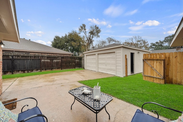 view of patio featuring a garage and an outbuilding