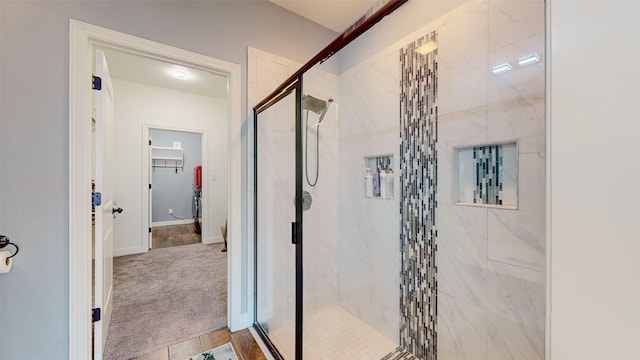 bathroom featuring a shower with shower door