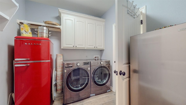 laundry area featuring washer and clothes dryer and cabinets