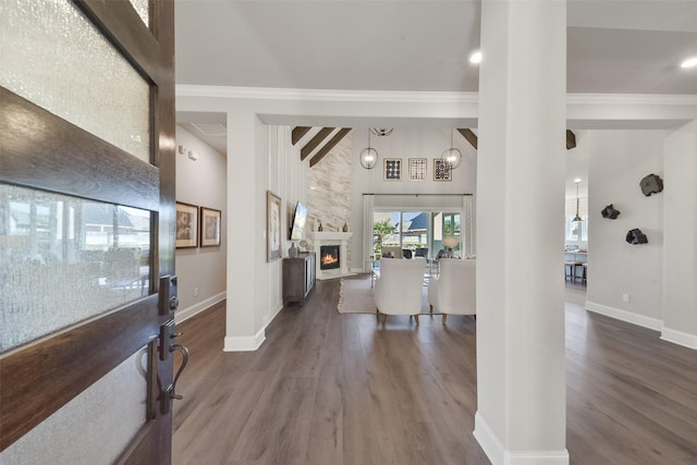 foyer entrance featuring a stone fireplace, crown molding, high vaulted ceiling, beamed ceiling, and hardwood / wood-style floors