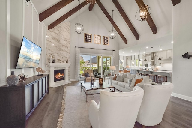 living room featuring beam ceiling, dark hardwood / wood-style flooring, a high end fireplace, and high vaulted ceiling