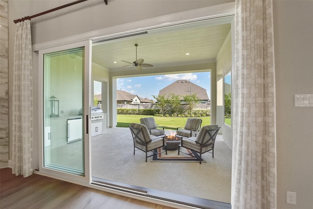 view of patio / terrace featuring grilling area, ceiling fan, and an outdoor fire pit