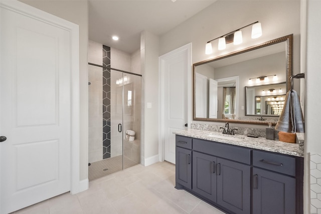 bathroom with vanity, tile patterned flooring, and a shower with shower door