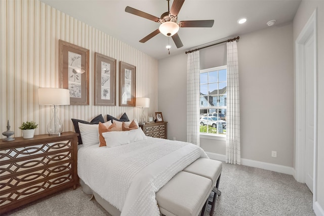 bedroom featuring light carpet and ceiling fan