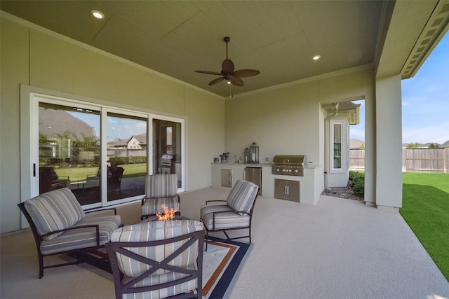 view of patio / terrace with an outdoor kitchen, area for grilling, ceiling fan, and an outdoor fire pit