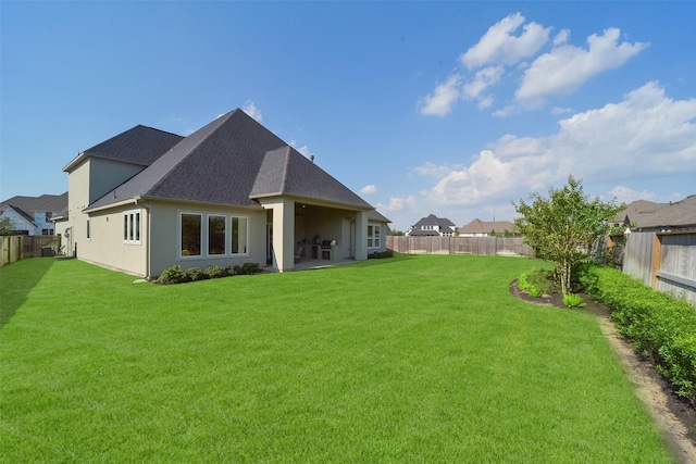 back of house featuring a yard