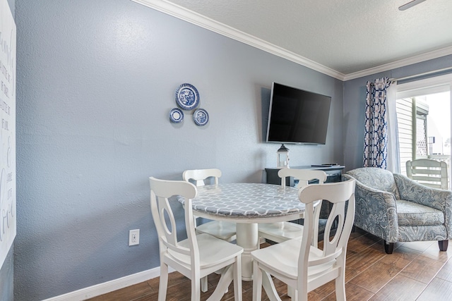 dining space featuring ornamental molding, dark hardwood / wood-style floors, and a textured ceiling