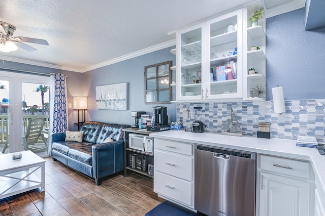 kitchen featuring tasteful backsplash, white cabinetry, stainless steel dishwasher, and crown molding