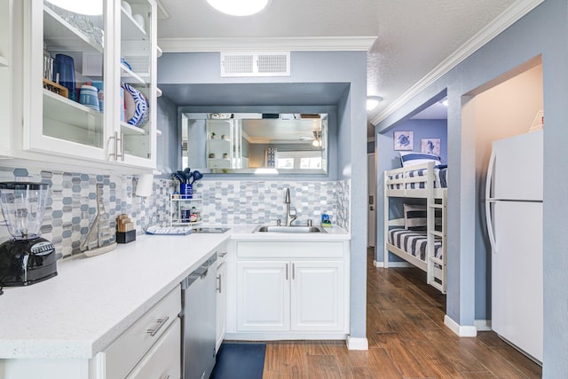 kitchen with sink, crown molding, white refrigerator, dark hardwood / wood-style floors, and white cabinets