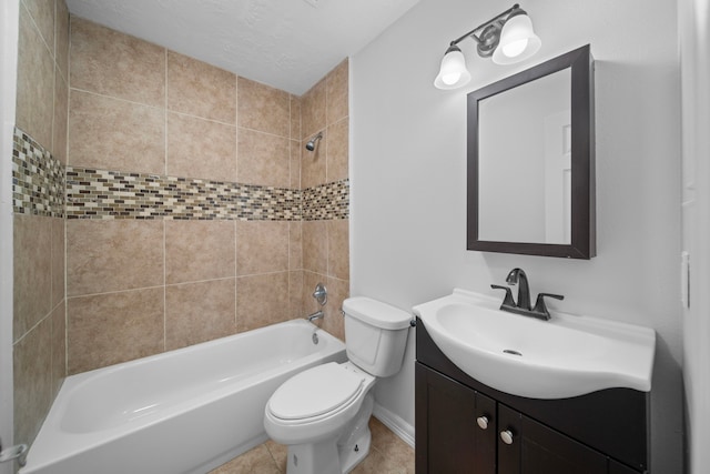 full bathroom featuring vanity, tile patterned flooring, tiled shower / bath combo, and toilet