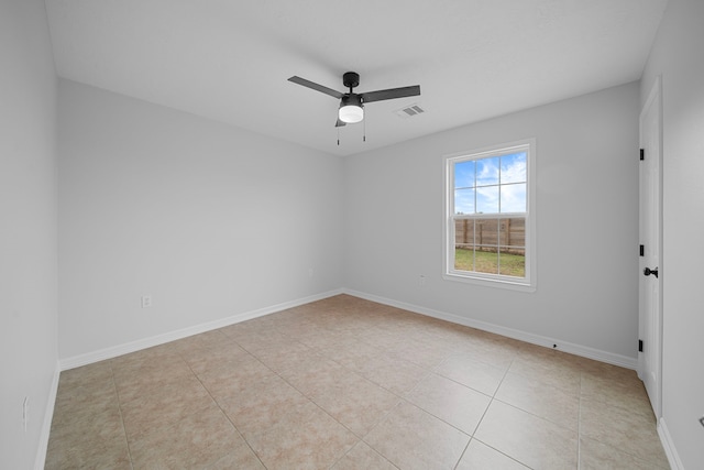 tiled spare room featuring ceiling fan