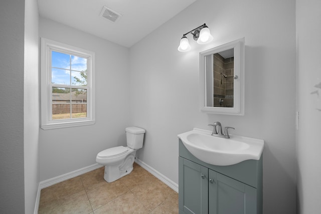 bathroom featuring vanity, tile patterned flooring, and toilet