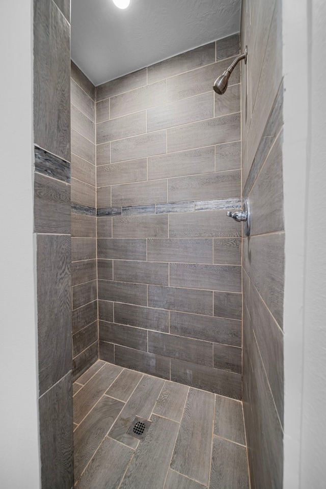 bathroom with a tile shower