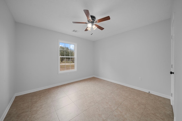 tiled empty room featuring ceiling fan