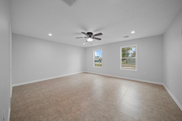 tiled spare room featuring ceiling fan