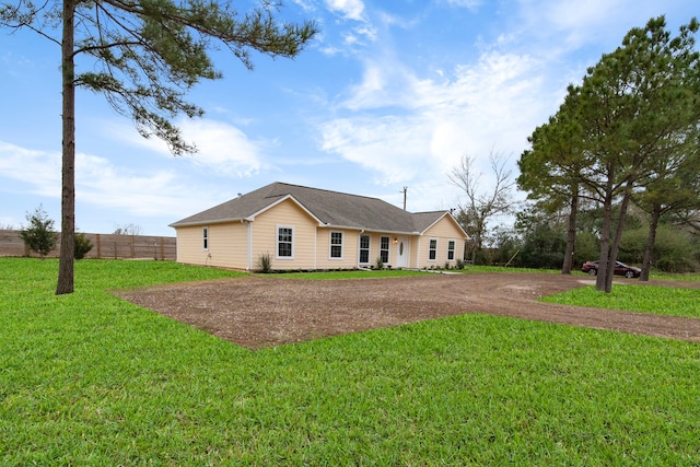 ranch-style home featuring a front yard