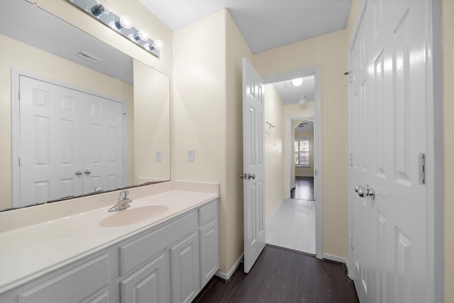 bathroom featuring hardwood / wood-style flooring and vanity