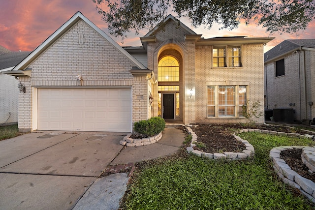 view of property with a garage and central air condition unit