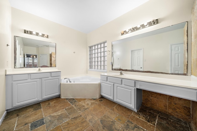 bathroom featuring vanity and a washtub