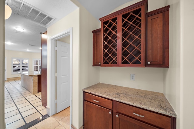 kitchen with light stone countertops and light tile patterned floors