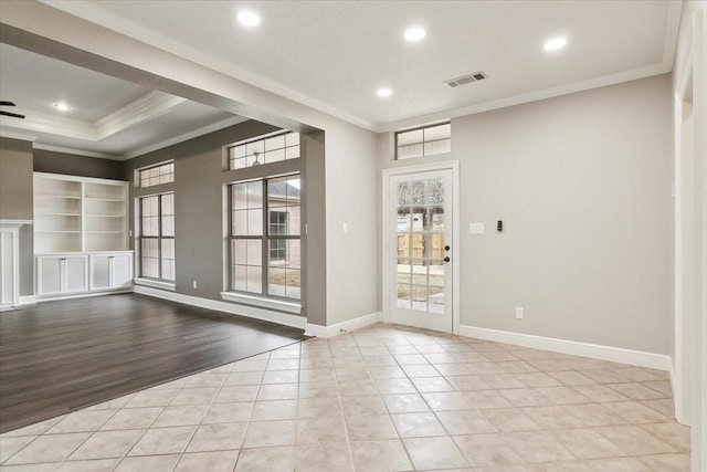 unfurnished room with ornamental molding and light tile patterned flooring