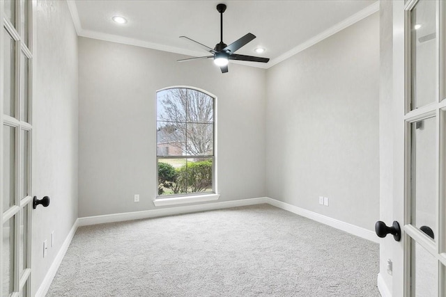 empty room featuring ornamental molding, carpet flooring, ceiling fan, and french doors