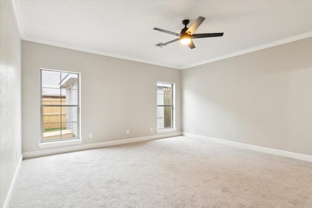 empty room with ornamental molding, carpet flooring, and ceiling fan