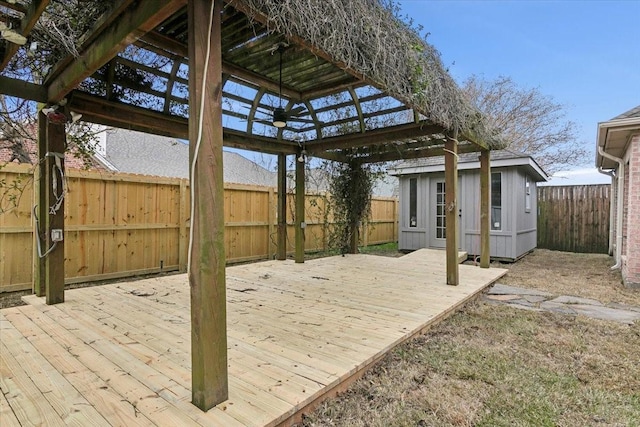 view of patio featuring a wooden deck and a storage unit