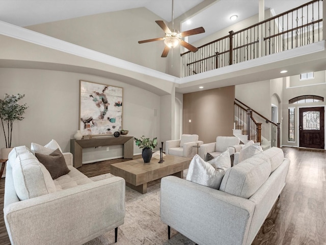 living room with ceiling fan, wood-type flooring, and high vaulted ceiling