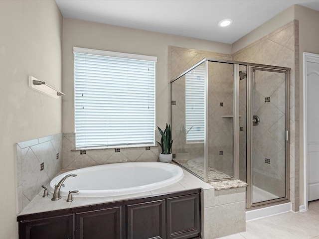 bathroom featuring plus walk in shower and tile patterned floors