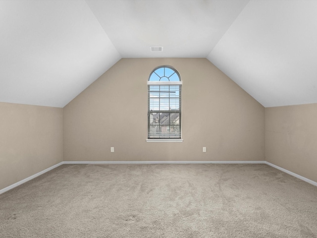 bonus room featuring vaulted ceiling and carpet flooring