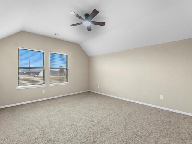 additional living space featuring ceiling fan, vaulted ceiling, and carpet