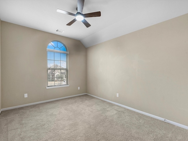 carpeted spare room with vaulted ceiling and ceiling fan